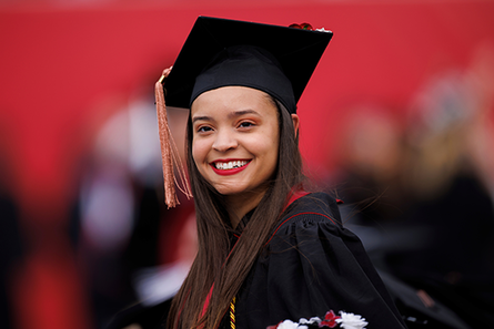 Four students wearing graduation cap and gown